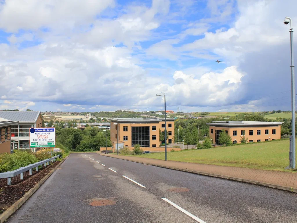 Offices at Capability Green business park in Luton with a plane overhead from London Luton Airport - IT support for Capability Green businesses from Total Group