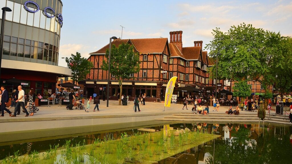 The pond and shops on The Parade, Watford High Street, Hertfordshire